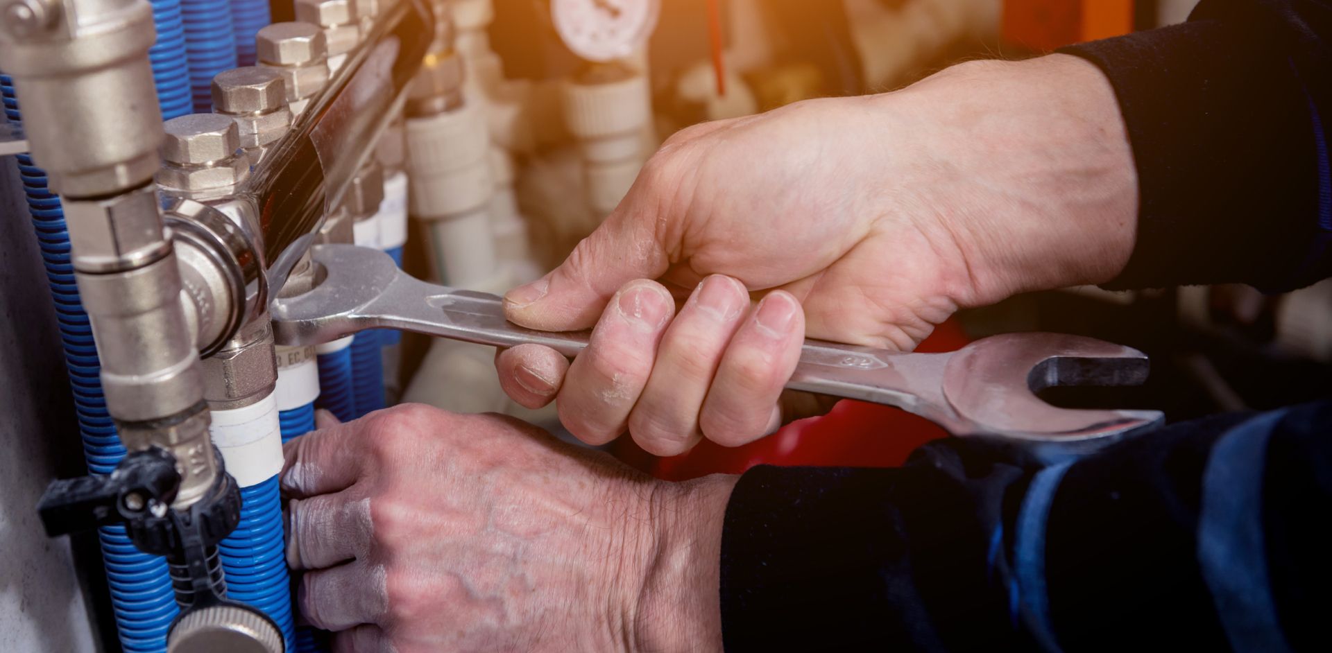 Ein Handwerker schraubt an einem Ventil